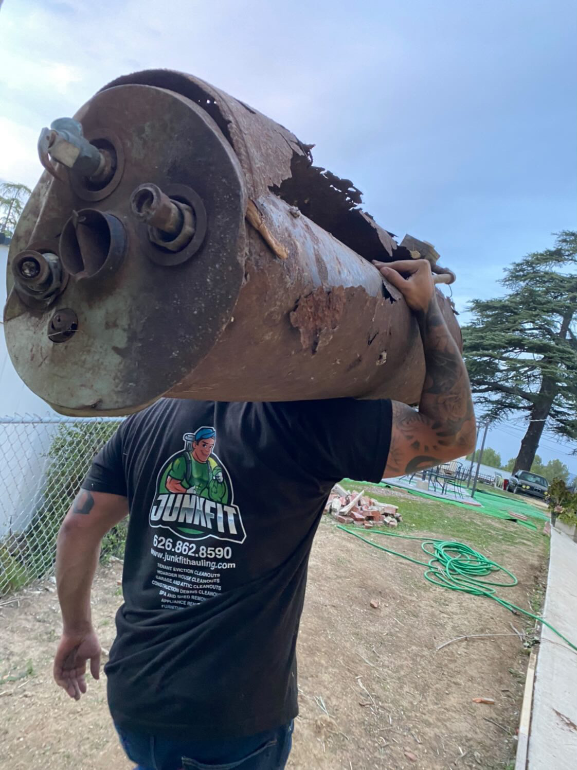 JunkFit crew member carrying heavy equipment