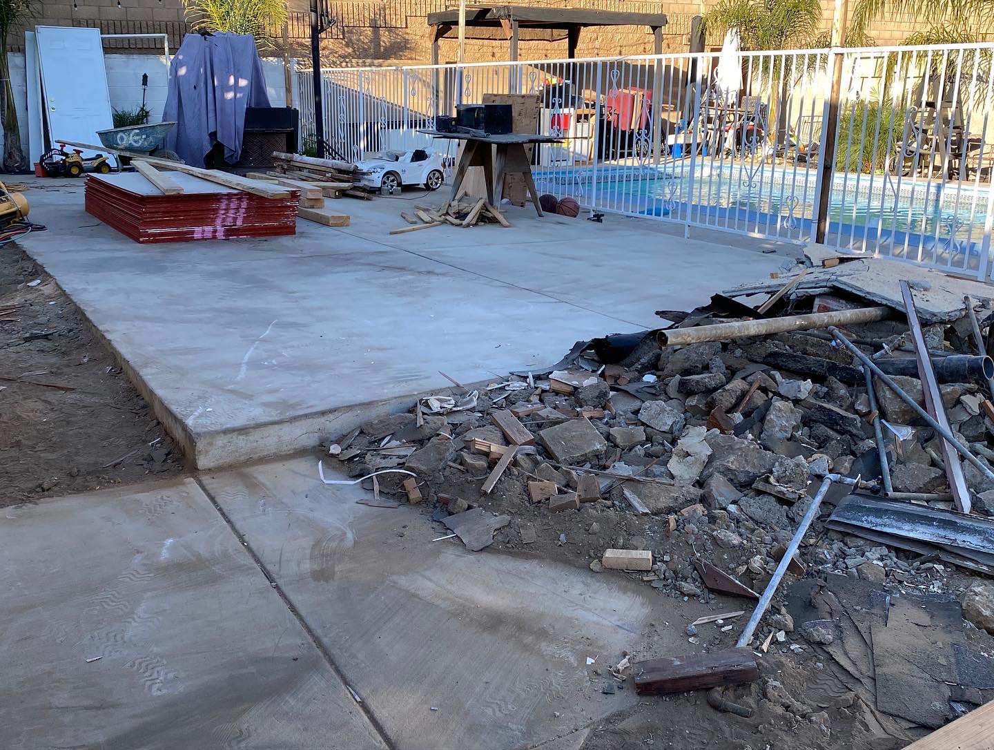 After: cleared backyard with clean concrete pad