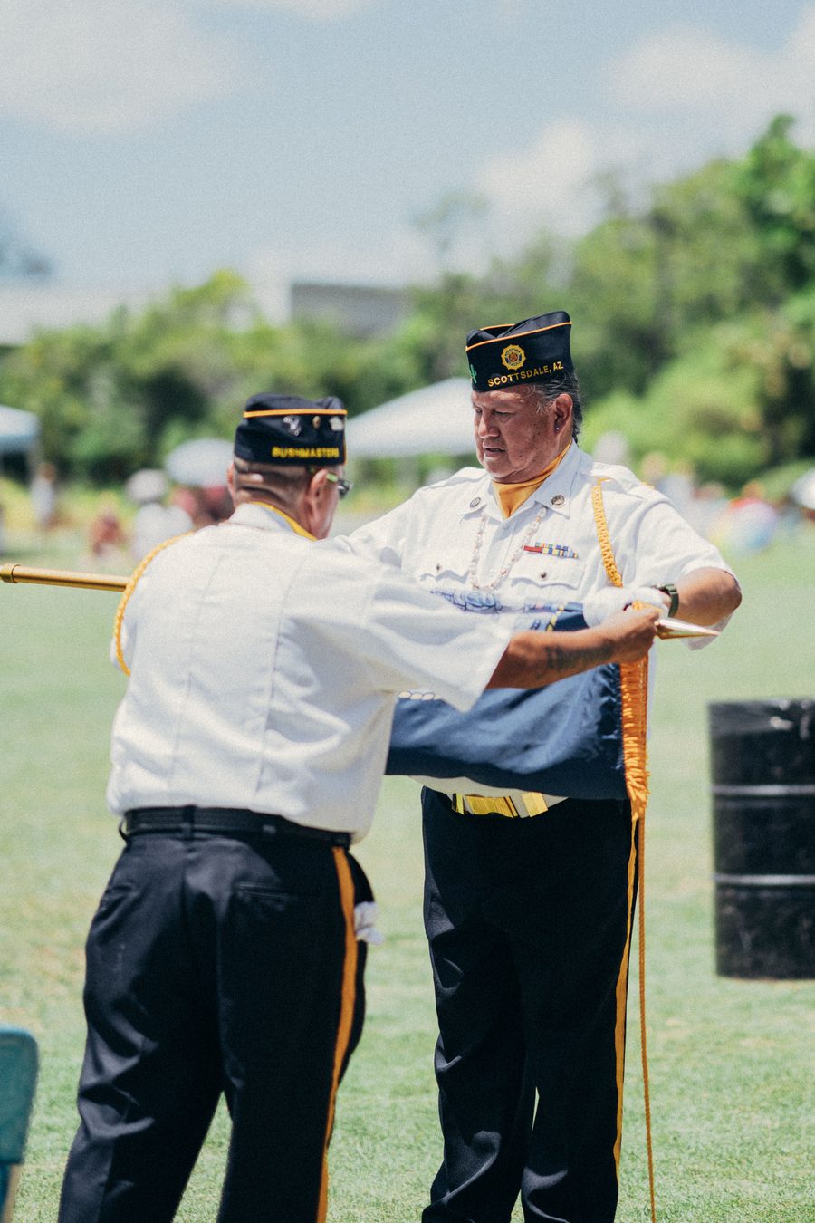 Two American Legion veterans folding an American flag with honor