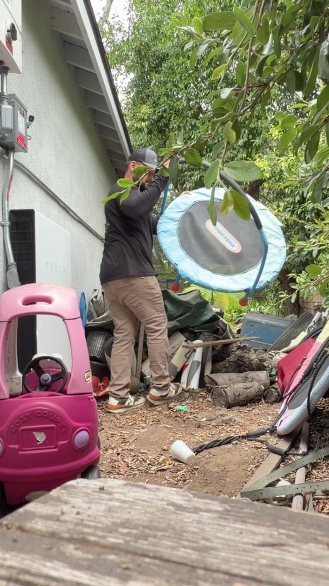 JunkFit crew hauling an old trampoline during a Glendora yard cleanout