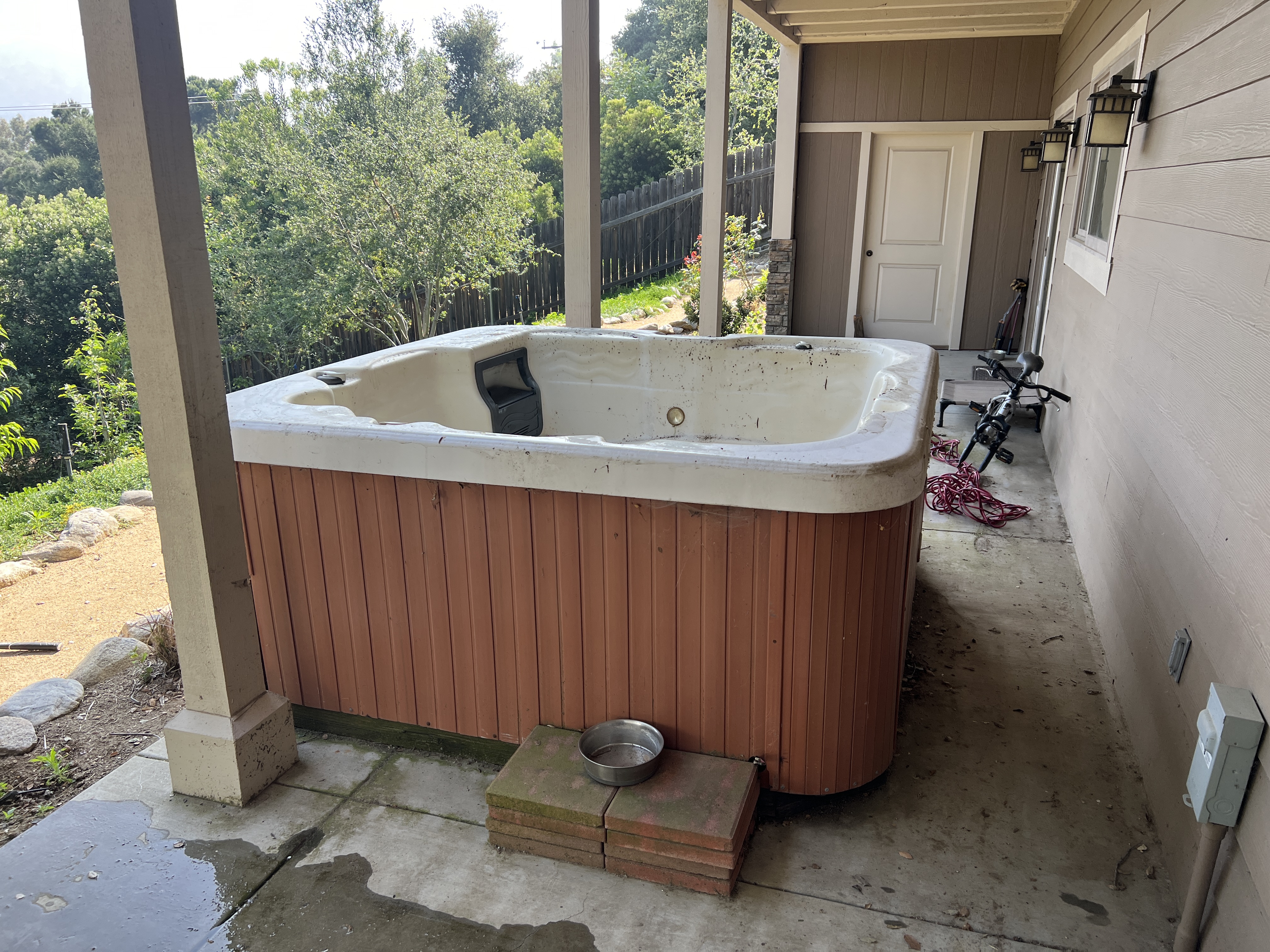 Before: old hot tub on patio