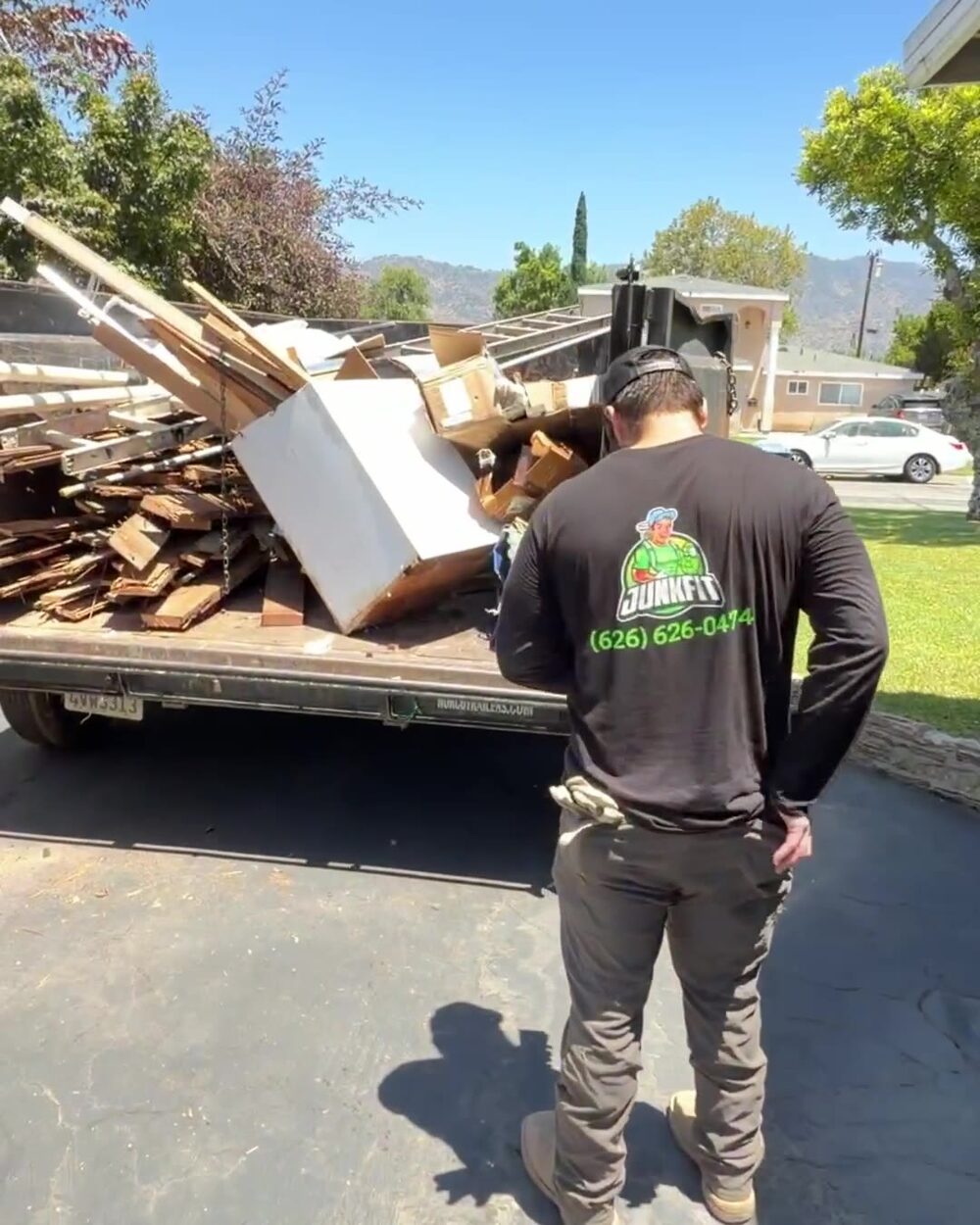Trailer loaded with shed debris hauled from a Glendora backyard